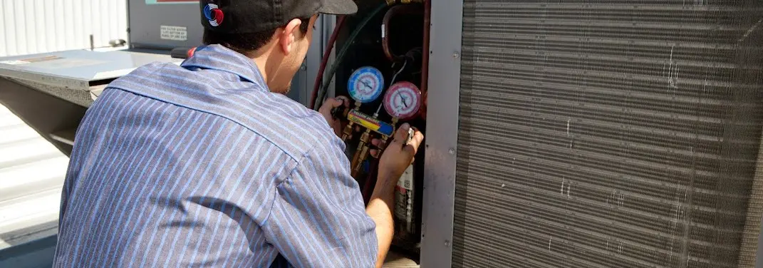 HVAC technician servicing a condenser unit in Bothell East