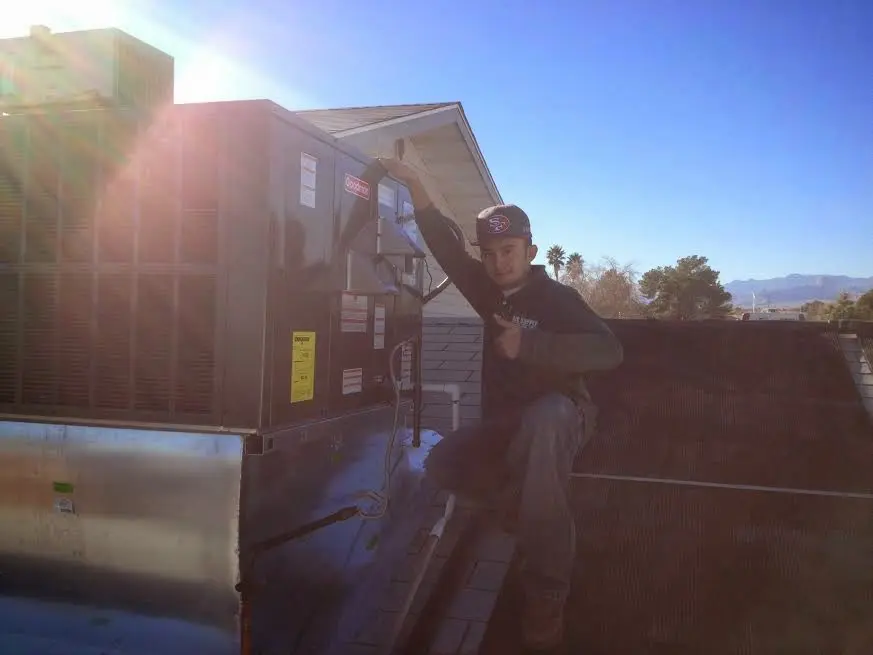HVAC technician performing Boiler Repair on a rooftop unit in Bothell East